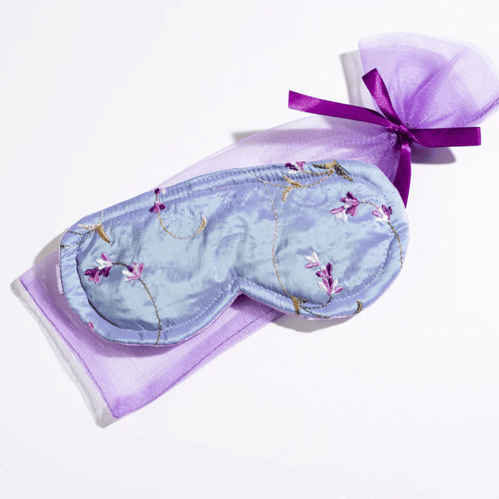 Sleep Mask Lavender In Embroidered Satin | Sonoma Lavender with delicate floral embroidery, displayed on a lavender-colored sheer fabric pouch tied with a purple ribbon.