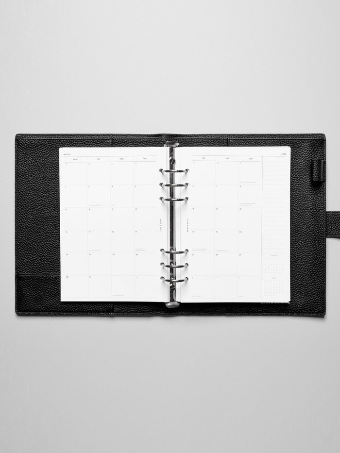 Image shows the Monday Start 2026 Dated Monthly Planner Inserts used in a black leather A5 ring-bound planner.