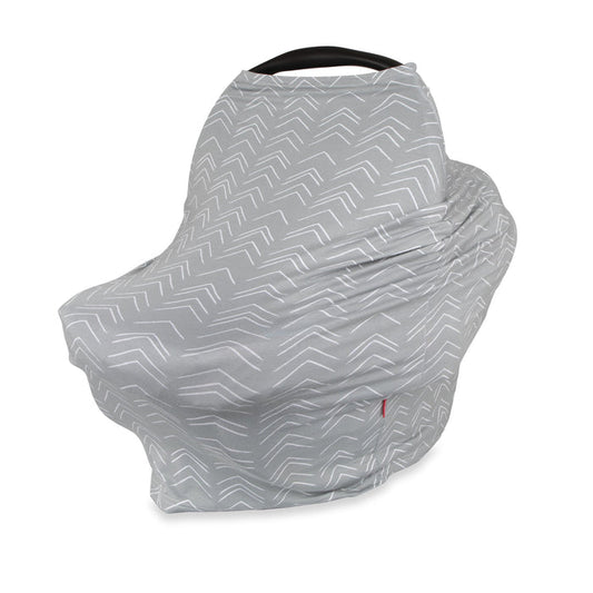 The 5-in-1 Multipurpose Nursing Cover features a gray and white chevron design, stretching over an infant car seat for full coverage. With the handle partially visible, it's a baby registry must-have and also serves as a nursing cover.