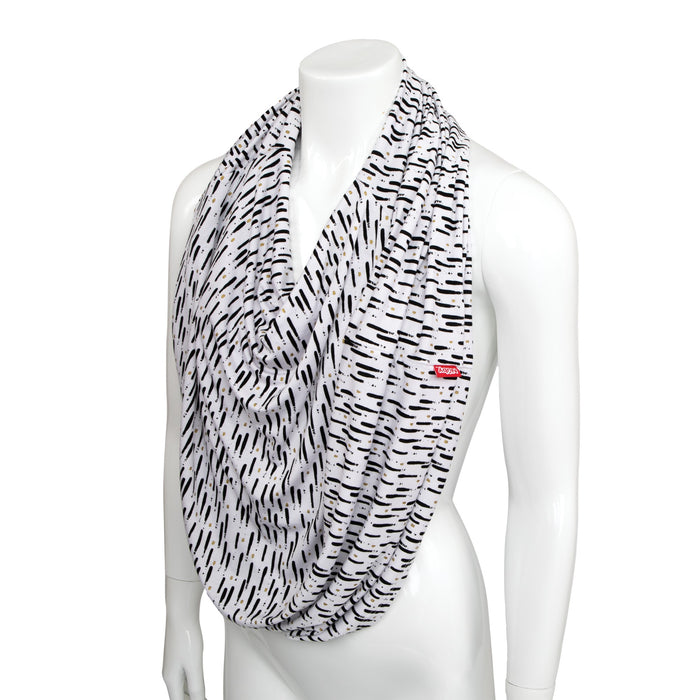 A white mannequin wears the 5-in-1 Multipurpose Nursing Cover, a black-and-white patterned infinity scarf with thin lines. It doubles as a nursing cover or infant car seat cover and features a small red tag with white text on one side.
