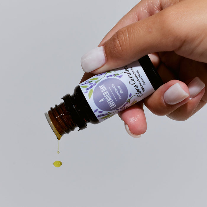 Lifestyle image of A Lavender Day Essential Oil Blend by Edens Garden showing a drop of oil