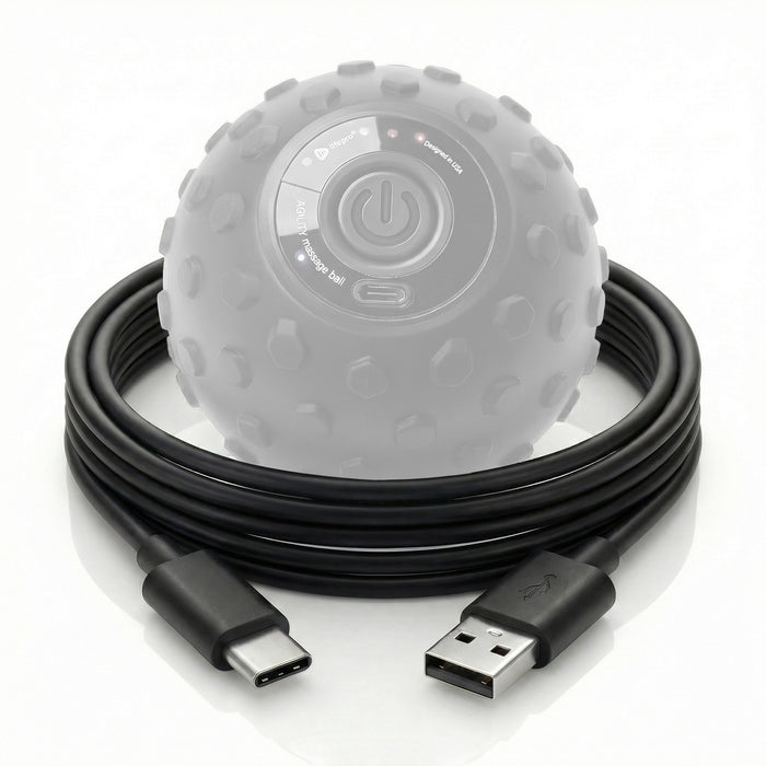 Coiled USB-A to USB-C charging cable in front of the LifePro Agility massage ball, showing its power button and USB-C charging port
