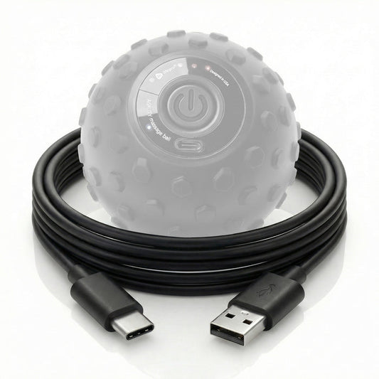 Coiled USB-A to USB-C charging cable in front of the LifePro Agility massage ball, showing its power button and USB-C charging port