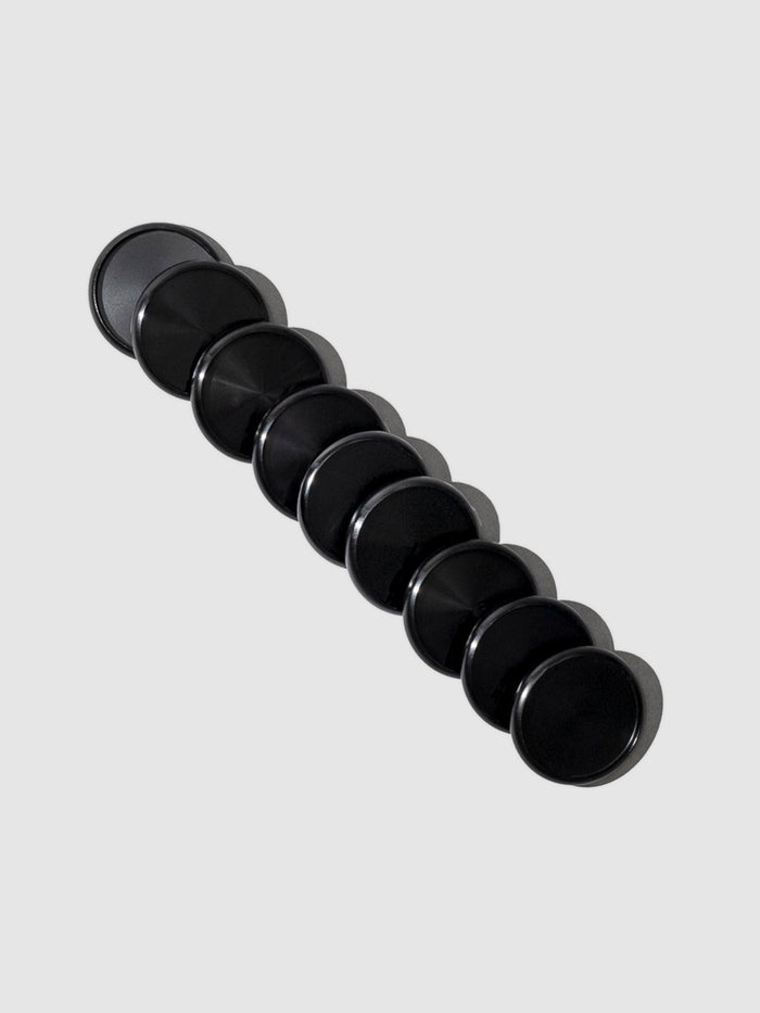 Planner Discs in Black Aluminum with a 1.25 inch diameter stacked to the left against a neutral background.