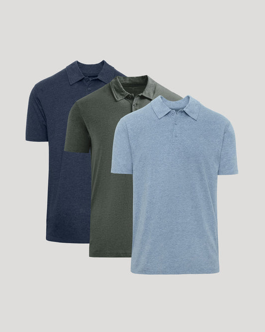 Three short-sleeve polo shirts in navy blue, olive green, and light heather blue, arranged in a staggered overlapping layout on a light gray background.
