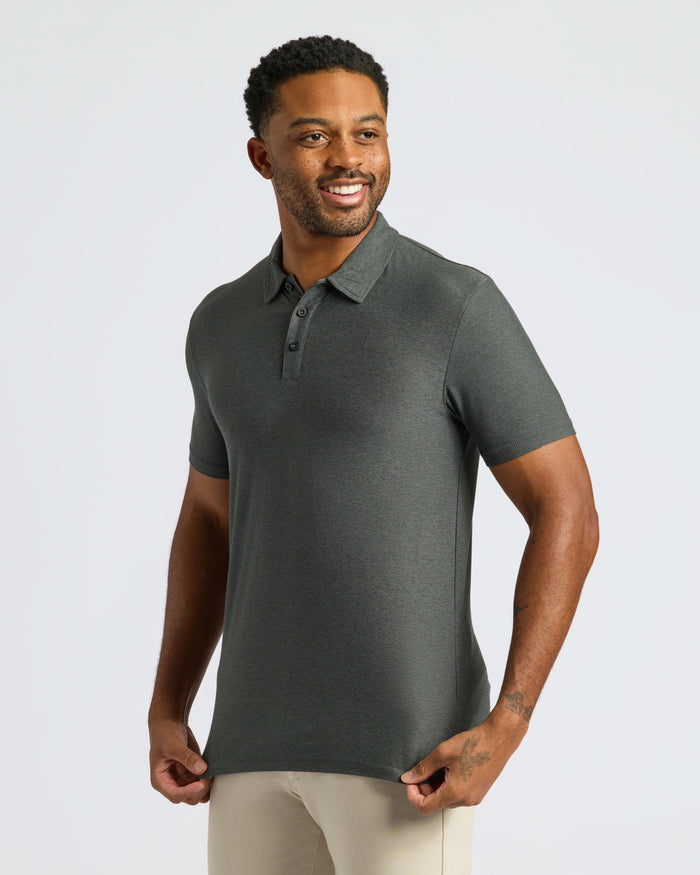 Man wearing Charcoal Heather Gray Classic Polo with beige pants, smiling.