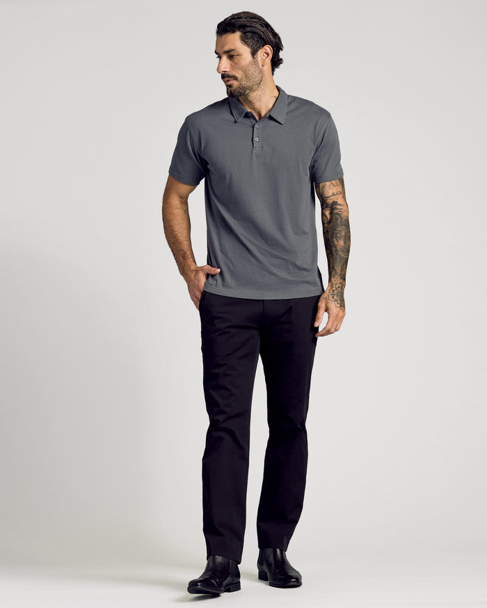 Man wearing Carbon Classic Polo with black pants and boots.