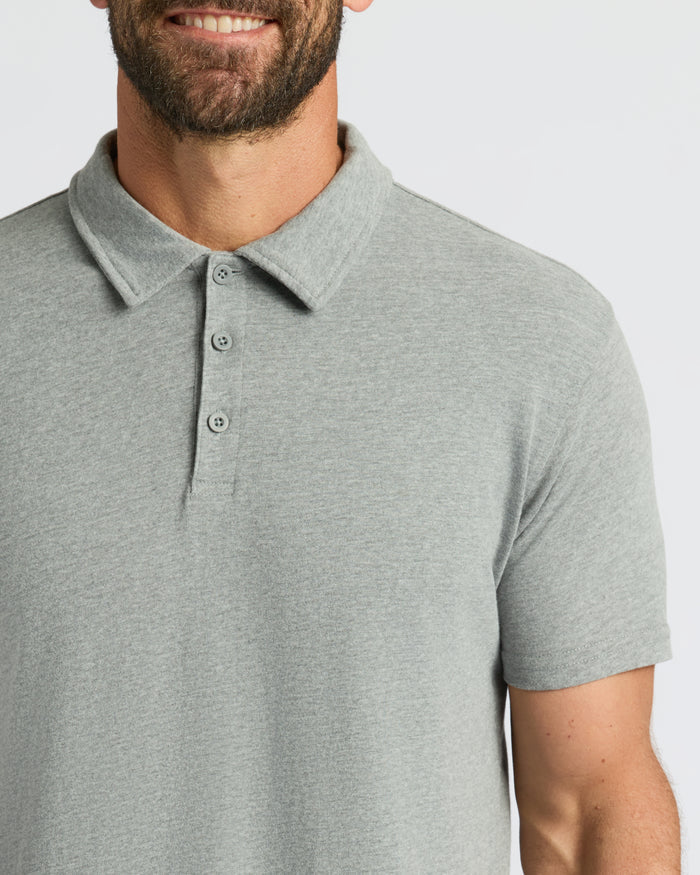 Man smiling in light-gray Classic Polo with three-button placket.
