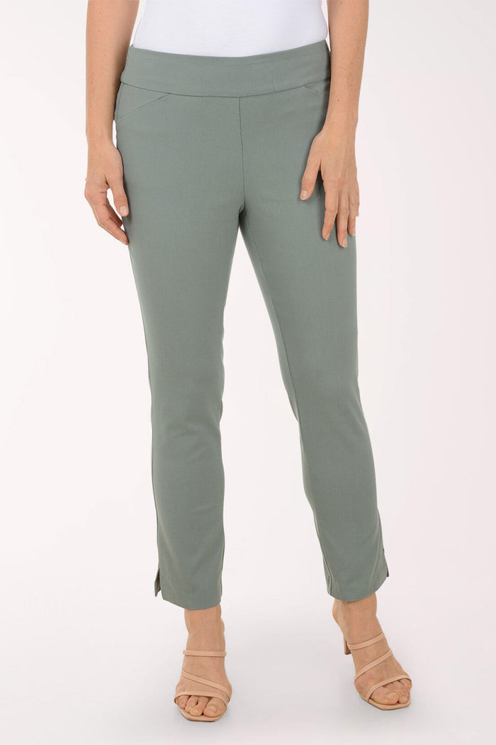 Green pants worn by a person on a white background