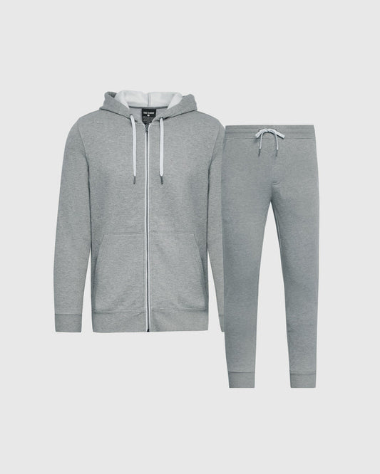 A two-piece gray fleece tracksuit set consisting of a zip-up hoodie with white drawstrings and matching jogger pants, displayed on a light gray background.