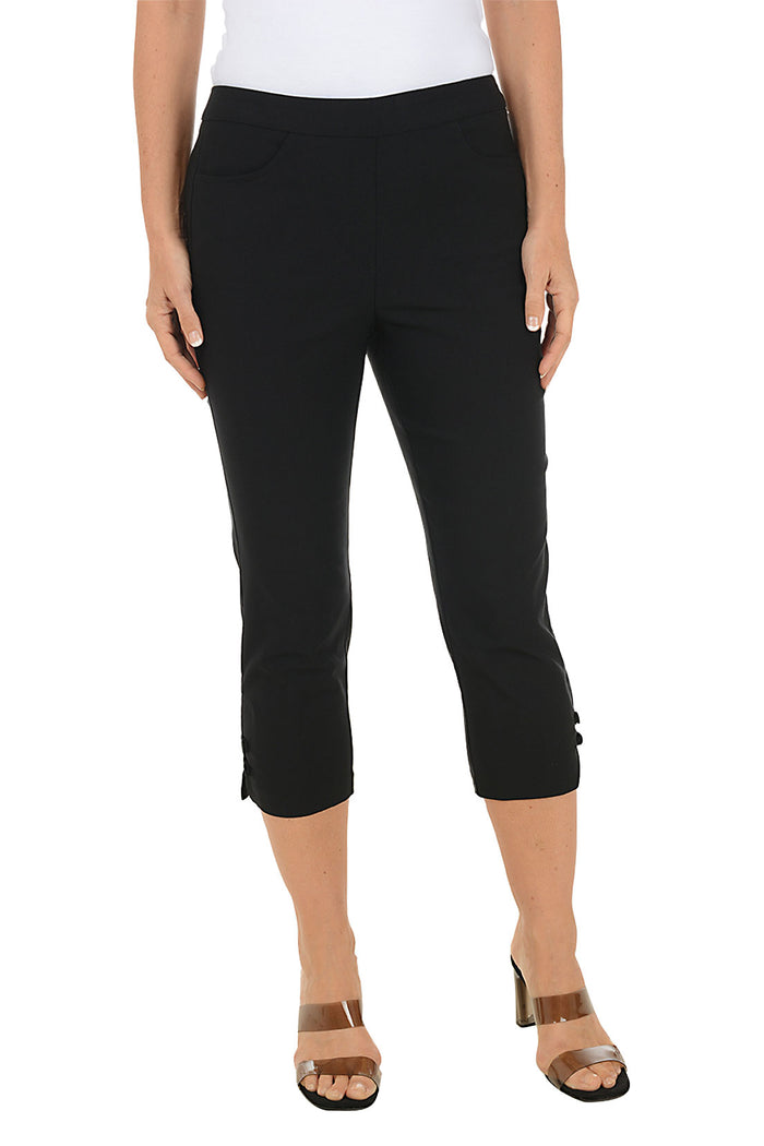 Person wearing black capri pants on a white background.