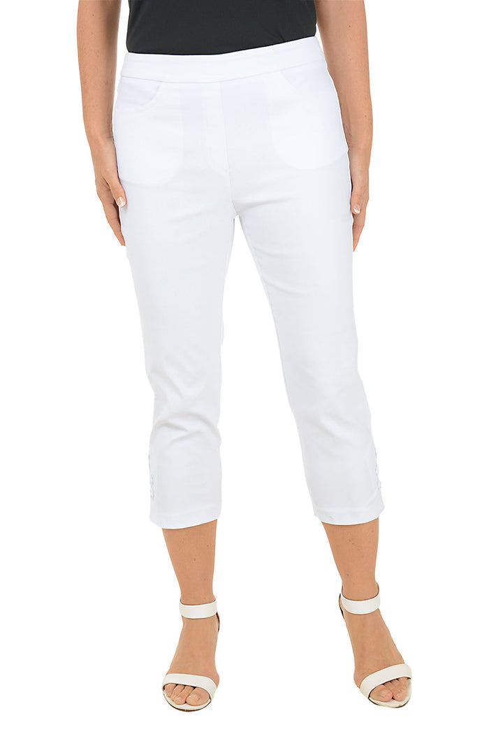 White capri pants worn by a person on a white background