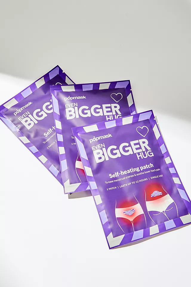 Three purple packages of Even Bigger Hug - 3 pack | Popmask self-heating patches for menstrual cramps and lower back pain relief, displayed on a white surface.