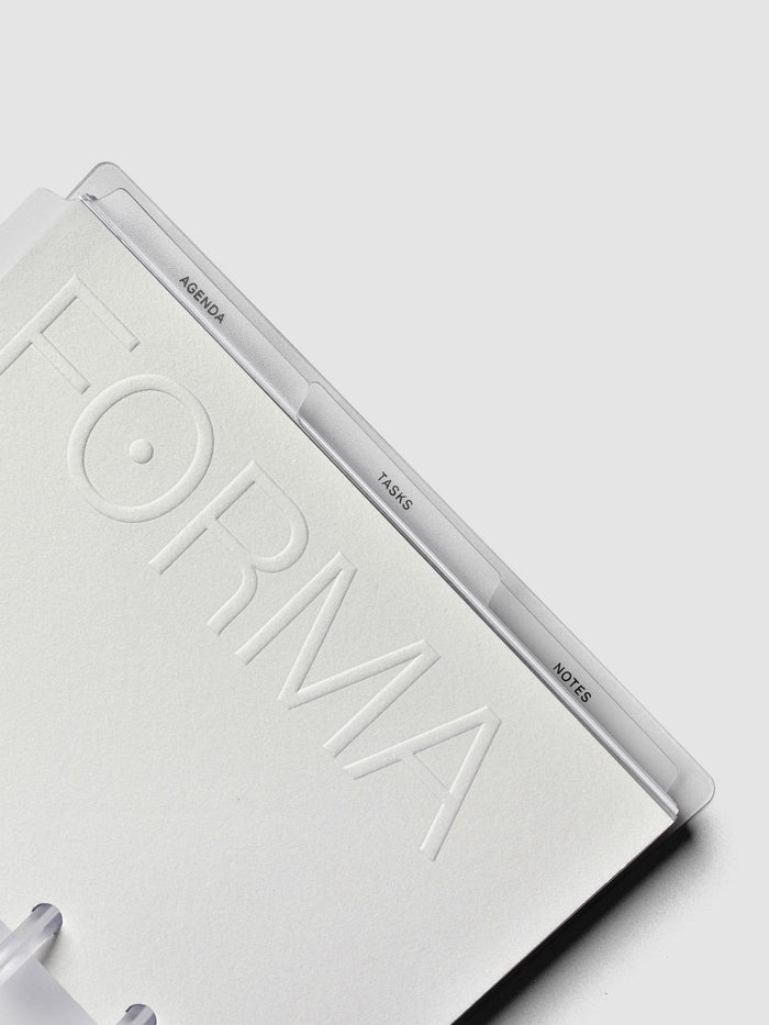 Open discbound planner with three clear side tab dividers labeled 'agenda', 'tasks', and 'notes'.