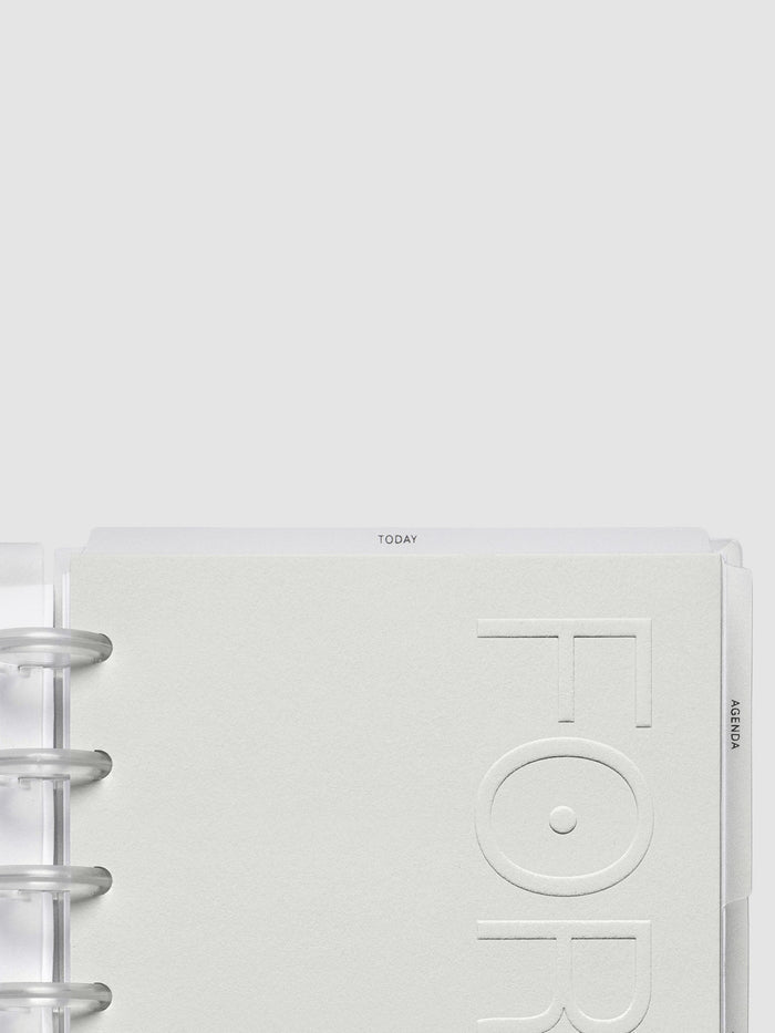 Forma Modular Planner System in size Half Letter showing the neutral cardstock embossed planner dashboard reading Forma.