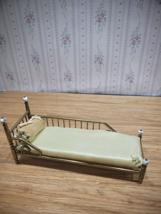 Gold Metal Bed with Round Pillow and Golden Mattress