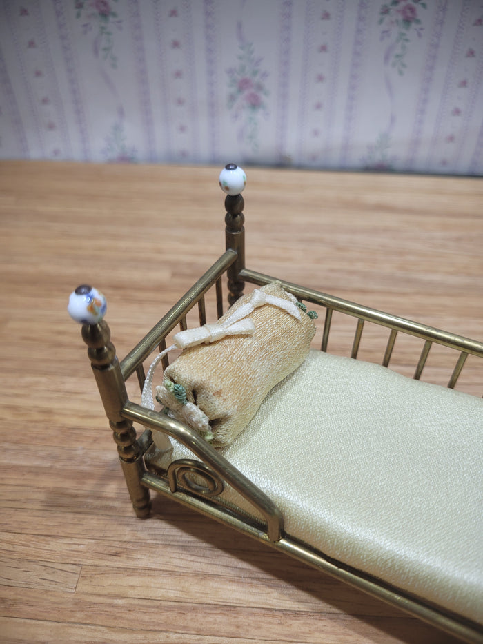 Gold Metal Bed with Round Pillow and Golden Mattress