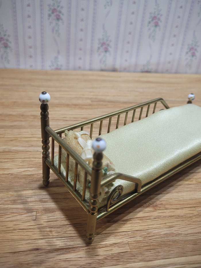 Gold Metal Bed with Round Pillow and Golden Mattress