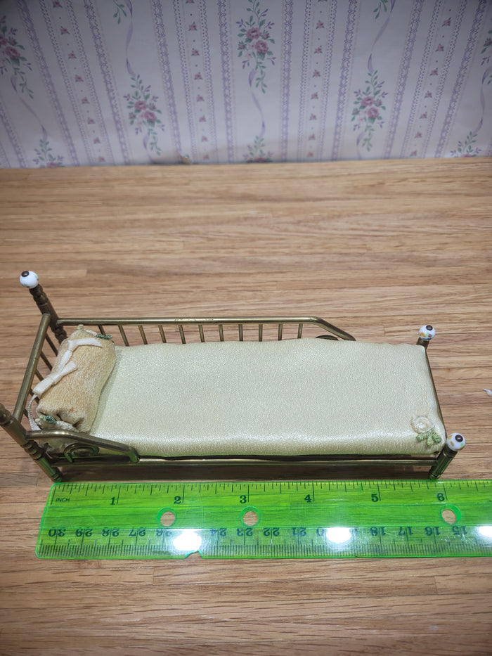 Gold Metal Bed with Round Pillow and Golden Mattress