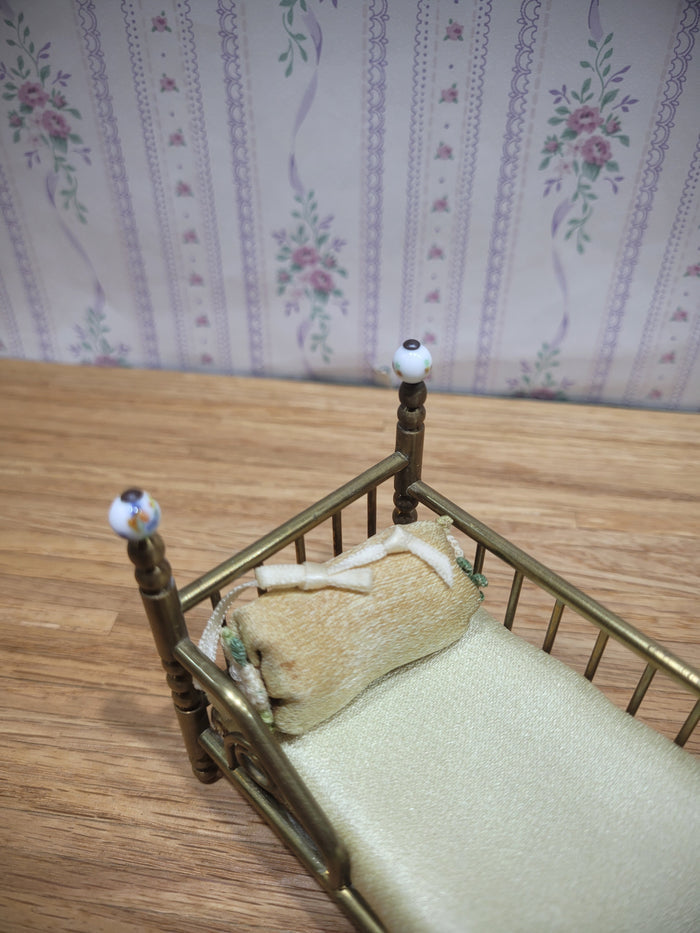 Gold Metal Bed with Round Pillow and Golden Mattress