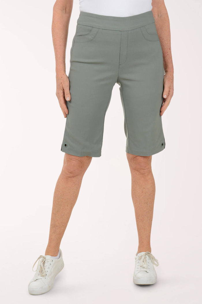 Person wearing green shorts on a white background