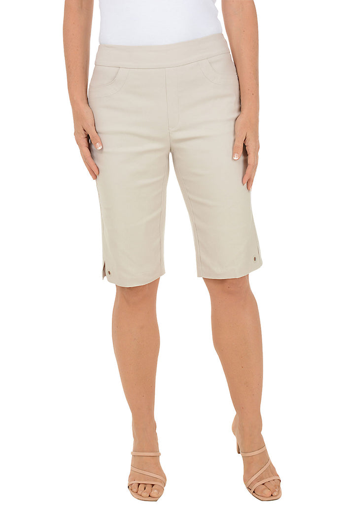 Beige shorts worn by a person on a white background