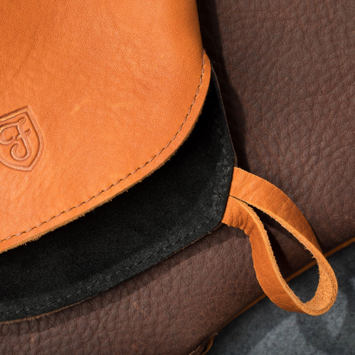 Detail of a Field Leather Oven Mitt showing the stitched hanging loop and tan grain