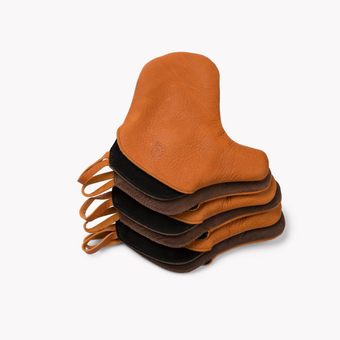 Stack of Field Leather Oven Mitts in tan, black, and brown leather