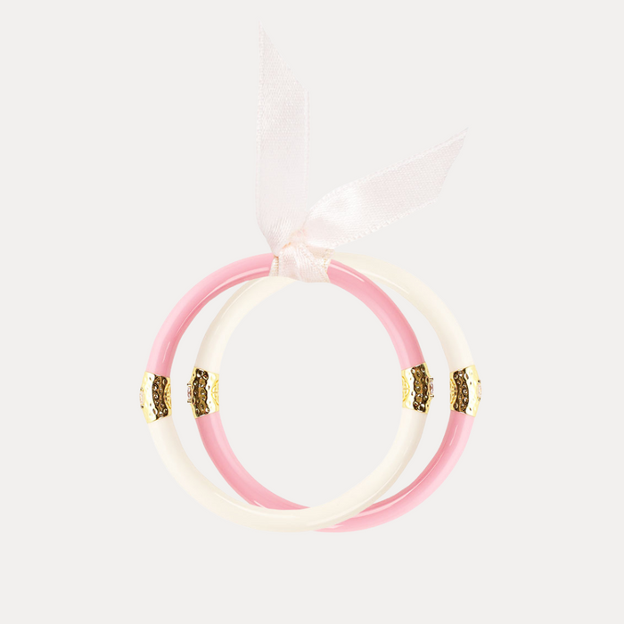 a pink and white bracelet with a ribbon