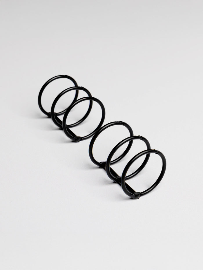 Planner rings displayed on a neutral background. Color shown is black.