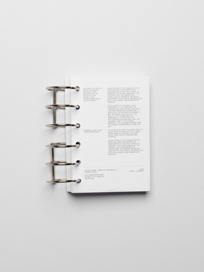 Planner rings displayed in a planner on a neutral background. Color shown is black.