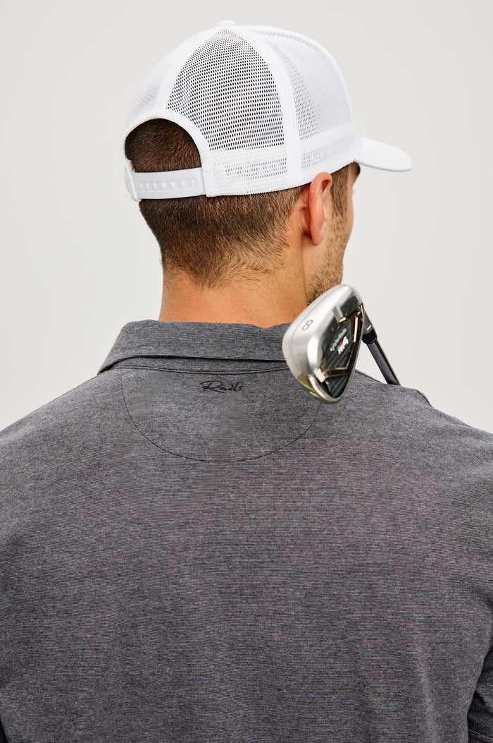 Golf Hat With Embroidered Branded Patch at Front, Adjustable Snapback, Mesh Back, and 6-Panel Construction in White Colorway - Upper Body Back View Featured on Model