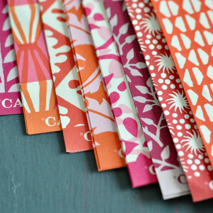 Set of colorful patterned paper strips on a dark surface