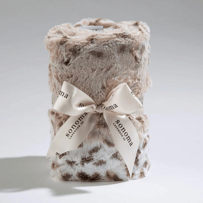 Spa Heat Wrap | Sonoma Lavender soft plush heat wrap in neutral tones with a branded ribbon, designed for soothing warmth and relaxation in body care and wellness routines.