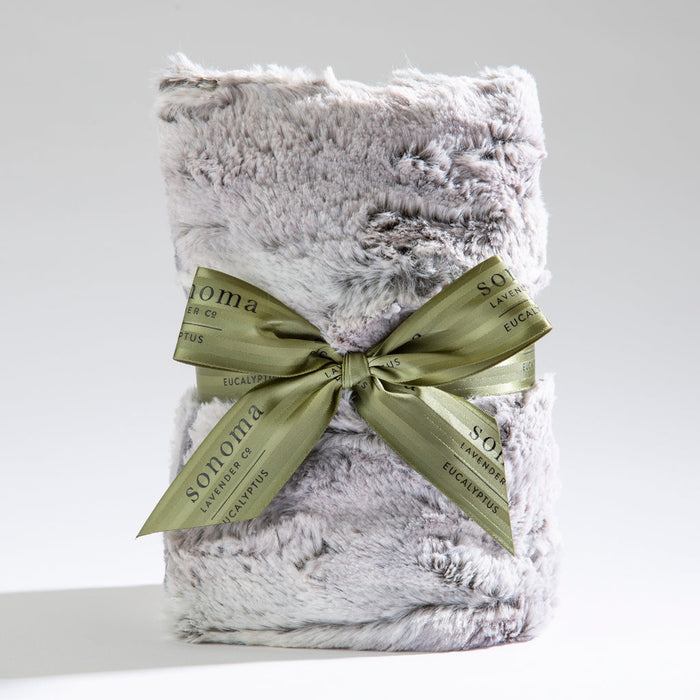 Spa Heat Wrap | Sonoma Lavender wrapped in a soft, plush silver-gray fabric with a green ribbon tied in a bow, designed for soothing body care and wellness recovery.