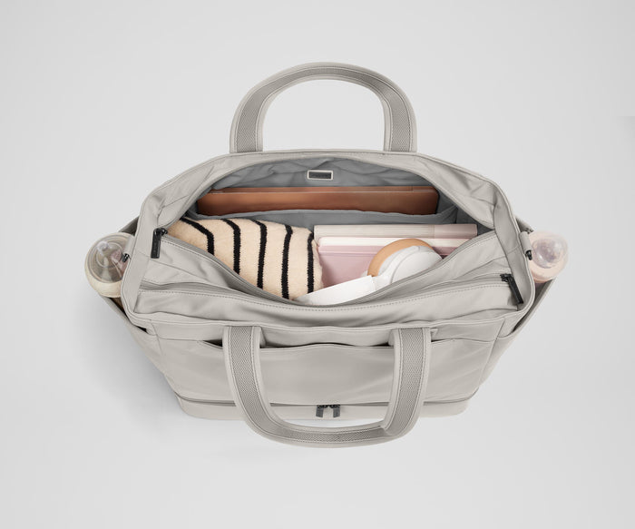 Back main compartment packed with adult travel essentials, including a laptop, notebook, and extra clothes
