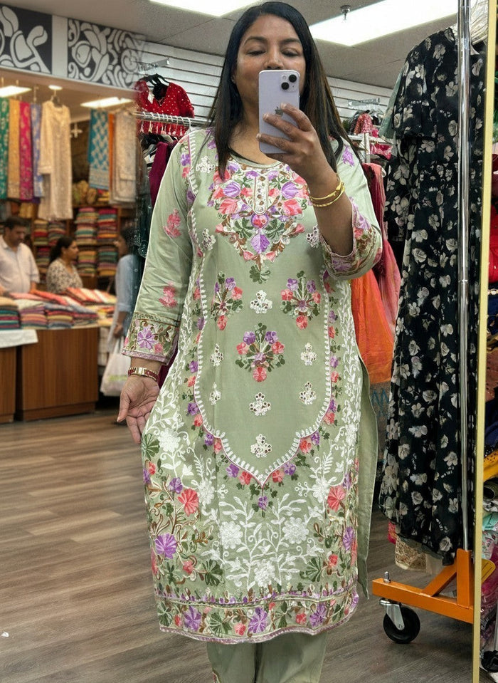 Kurti Connection USA sage green kurti set with intricate multi-colored floral embroidery and three-quarter sleeves.