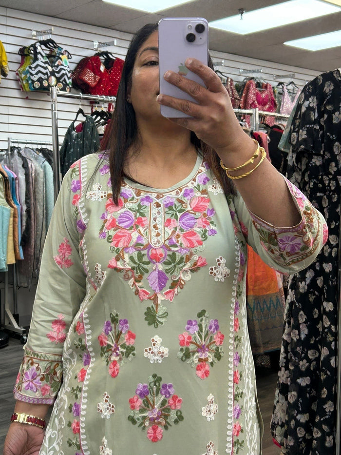 Kurti Connection USA sage green kurti with intricate multi-colored floral embroidery, round neck, and 3/4 sleeves.