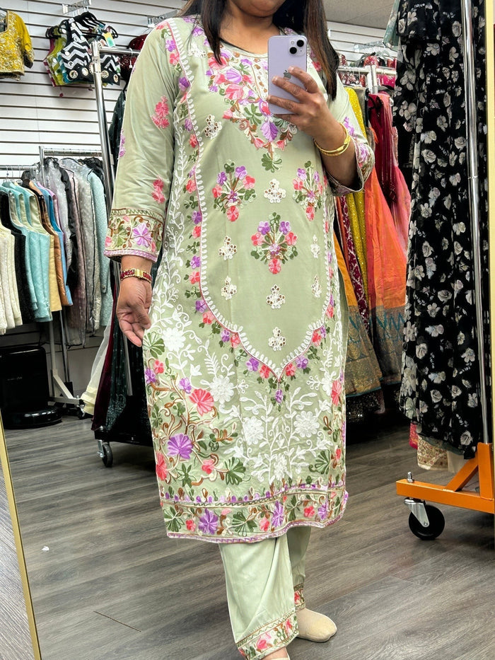 Kurti Connection USA sage green kurti set with intricate multi-colored floral embroidery and three-quarter sleeves.
