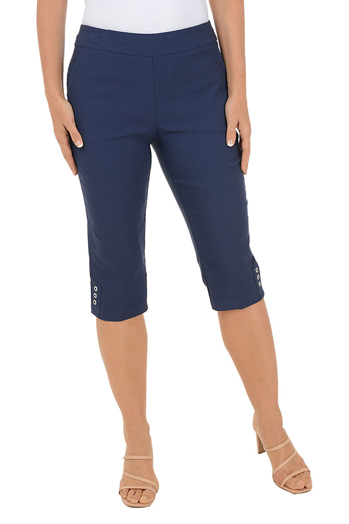 Navy blue capri pants worn by a person on a white background