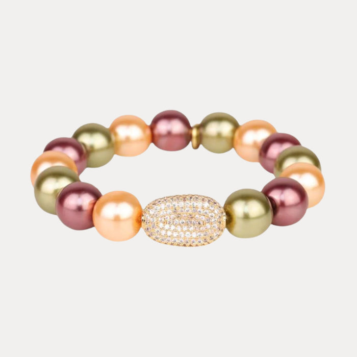 a bracelet with pearls and a gold object