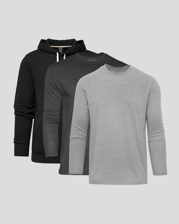 Three long-sleeve shirts in black and gray on a light gray background