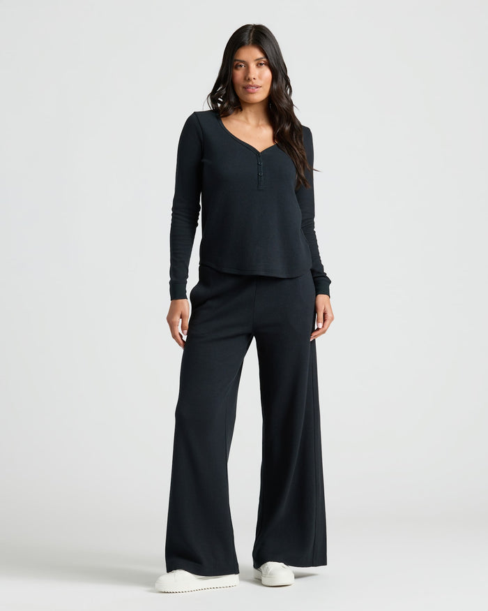 Womens Black Waffle Long Sleeve Henley & Waffle Leg Pant set worn by model. MODEL_INFO: Sophia is 5'8", wearing a size XS