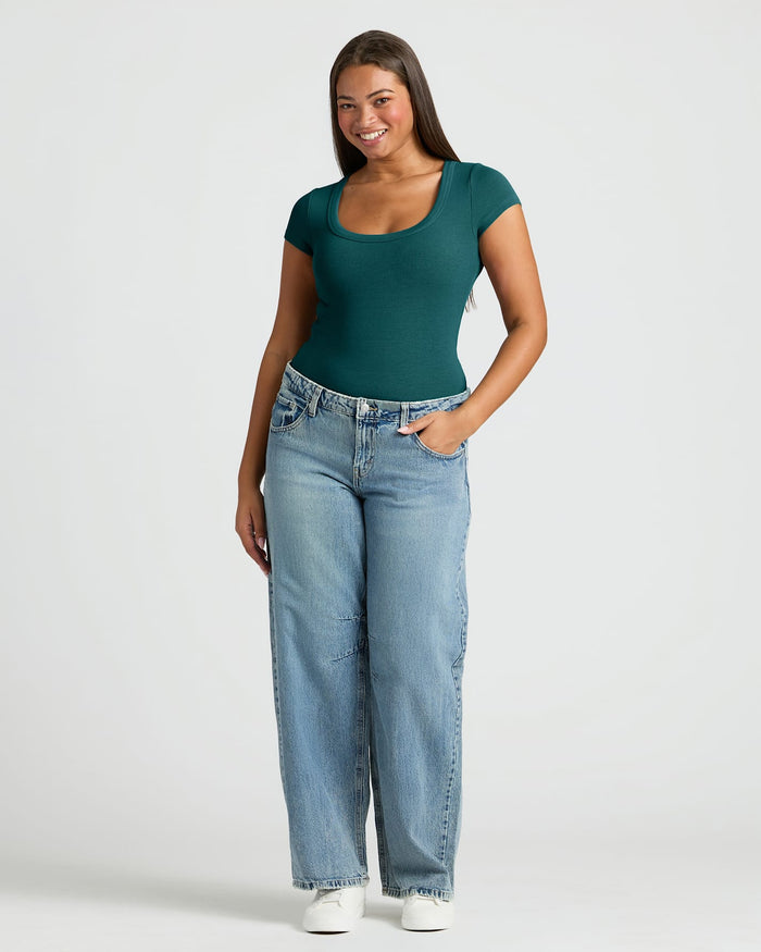 Woman wearing Womens Deep Emerald Ribbed U-Neck Tee, showcasing its flattering fit.