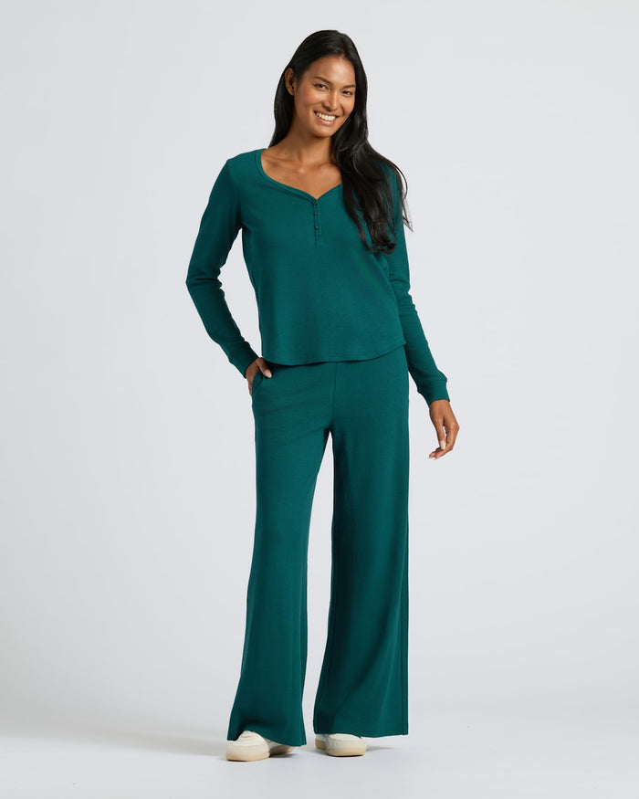 Woman in Womens Deep Emerald Waffle Long Sleeve Boxy Henley set.