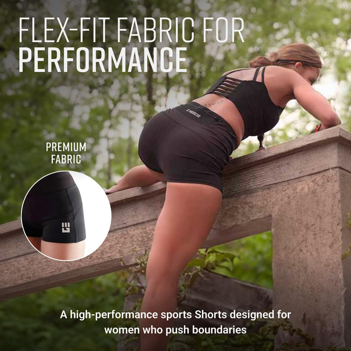 Woman in black compression shorts climbing wooden obstacle course wall