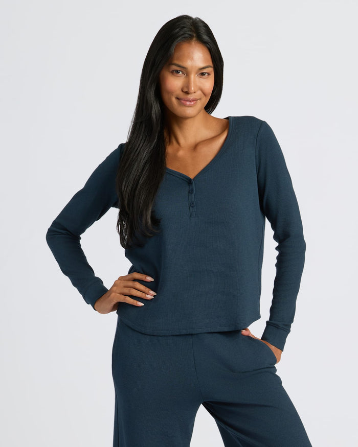 Woman in relaxed pose wearing Womens Navy Waffle Long Sleeve Boxy Henley.