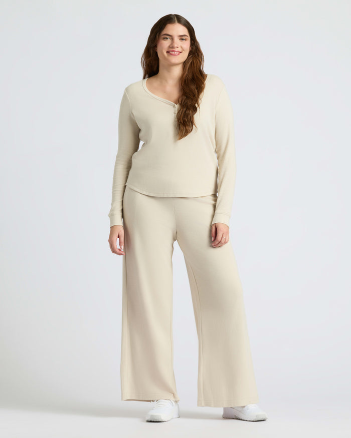 Woman in Womens Oatmeal Waffle Long Sleeve Boxy Henley, smiling.